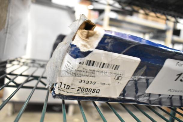 Box with torn edges and visible shipping label for a T&S MPY-8WLN-12-CR wall-mounted mini pre-rinse faucet, indicating scratch and dent condition.