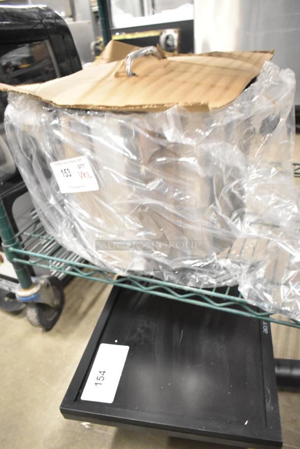 Brand new white mixing bowl and stainless steel stock pot in packaging. Minor scratches. Stock pot has a lid. Visible label: "153 QTY VNL."