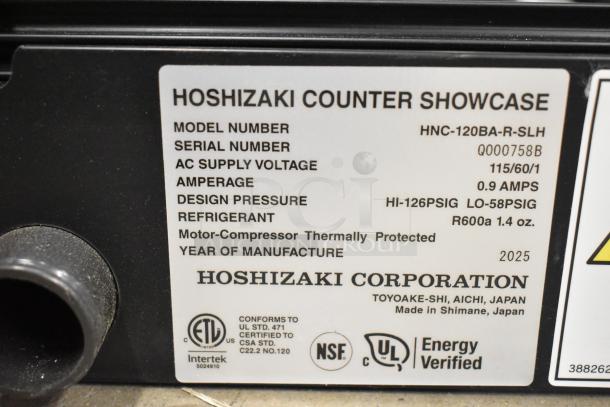 Label on Hoshizaki HNC-120BA-R-SLH refrigerated display case shows model details, voltage, amp, and refrigerant info.