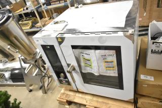 Brand new Bakers Pride AEHE061R stainless steel combi convection oven, 208V, 3-phase, slight scratches and dents visible.