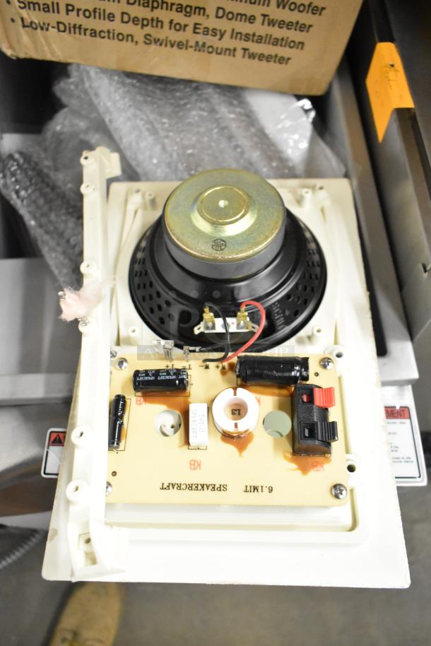 Box of Control 126WT in-wall loudspeaker, white frame, exposed components, new condition, packaging in background.