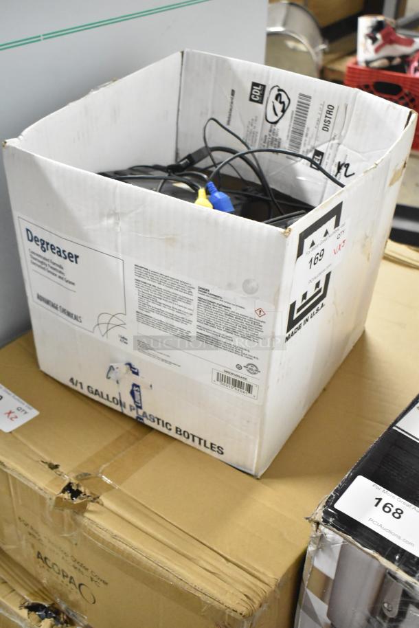 Box containing various electronics, including a receipt printer and credit card reader, in used condition. Box labeled "Degreaser."
