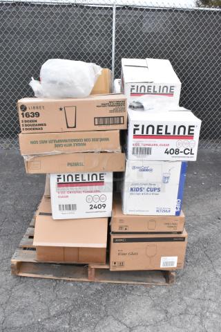Boxes of Fineline tumblers, Libbey glasses, kids' cups, and Acopa wine glasses on a pallet. New, scratch and dent items.