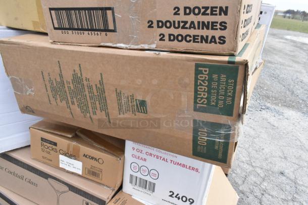 Boxes of brand new glasses and plastic tumblers, including Acopa Rocks Glass 12 oz, Renaissance Collection 9 oz crystal tumblers.