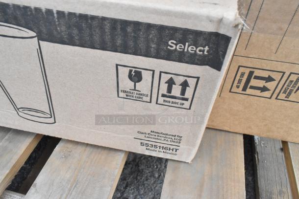Cardboard box with "Select" label, handling symbols, and "Manufactured for Clark Core Services, LLC" text. Contains 27 new scratch and dent glass/plastic tumblers.