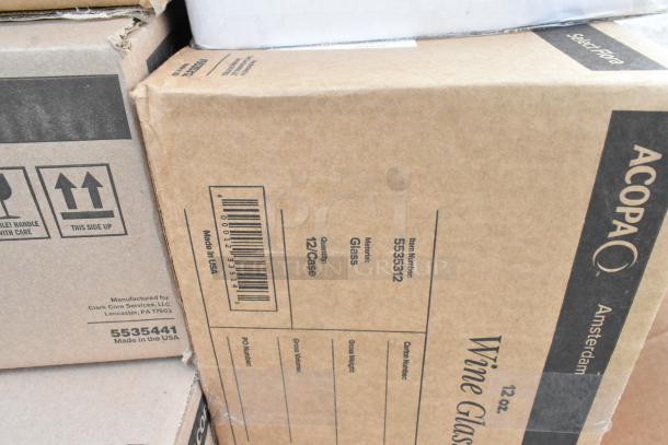 Cardboard boxes labeled "Acopa Amsterdam Wine Glasses, 12 oz." New condition, 12 glasses per case. Made in USA.