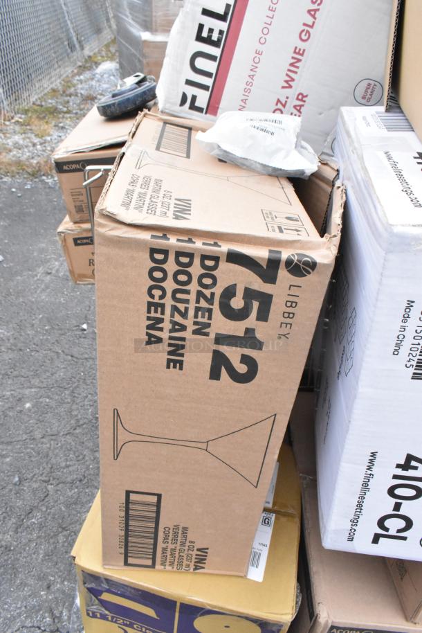 Boxes of Libbey glassware, including 8 oz martini glasses, labeled "1 dozen per box." Some boxes show signs of wear.