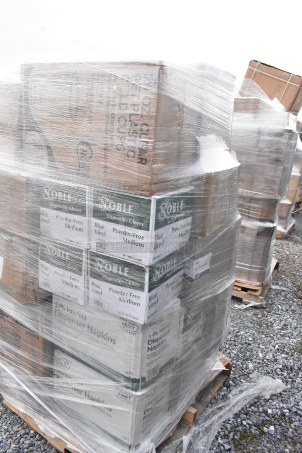 Pallet of scratch and dent items, including Noble disposable gloves and dispenser napkins, wrapped in plastic.