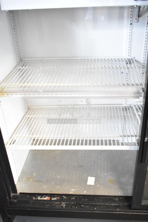2019 True TBB-24-60G-HC-LD commercial cooler, 2 glass doors, poly-coated racks, 115V, used condition.