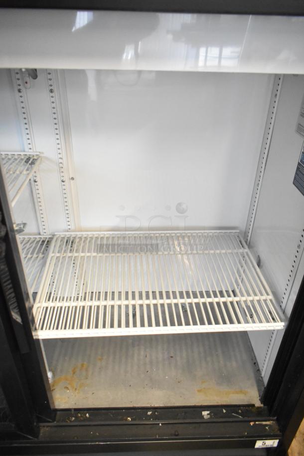 2019 True TBB-24-60G-HC-LD 2-door cooler with poly-coated racks. Metal interior with visible signs of use. 115V, 1-phase.