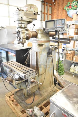 Bridgeport metal commercial milling machine with Turnvision monitor, industrial floor model, showing wear and patina.