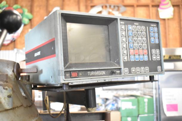 Bridgeport metal milling machine with Turnvision monitor, featuring keypad controls and Achyte label, in used condition.