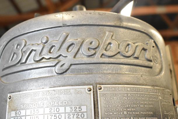 Bridgeport Metal Commercial Milling Machine, embossed branding, spindle speed chart, and high/low speed selection instructions visible.