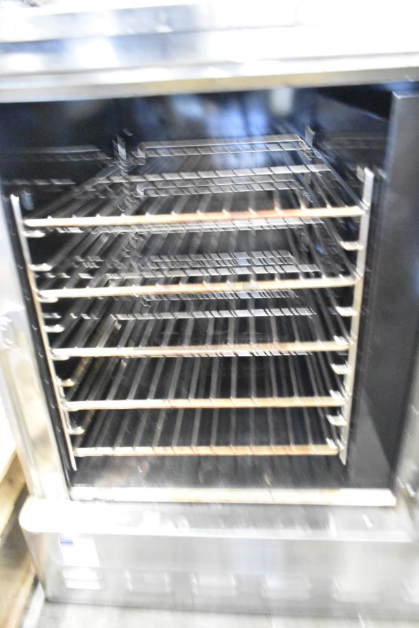 Blodgett stainless steel half-size convection oven with metal racks, solid door, and thermostatic controls. Gas powered.