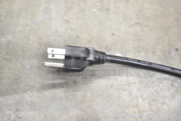 Close-up of a black power plug for a Lancer TP 30 carbonated beverage machine.