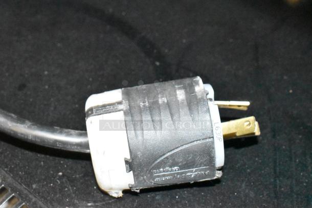 Hussmann MDN3575B1A commercial merchandiser plug. Black connector labeled L630P, with gold prongs, on a dark background.