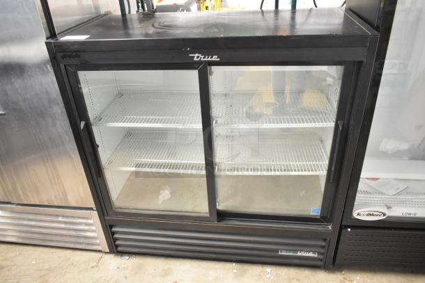 2020 True GDM-41SL-48-HC-LD commercial cooler, 2 glass doors, poly-coated racks, 115V, black metal exterior, excellent condition.