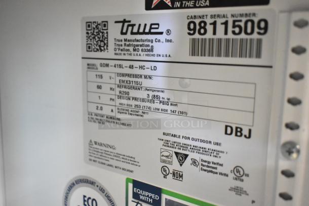 2020 True GDM-41SL-48-HC-LD, a metal commercial 2-door reach-in cooler, 115V, 1 phase, with poly-coated racks. Serial: 9811509.