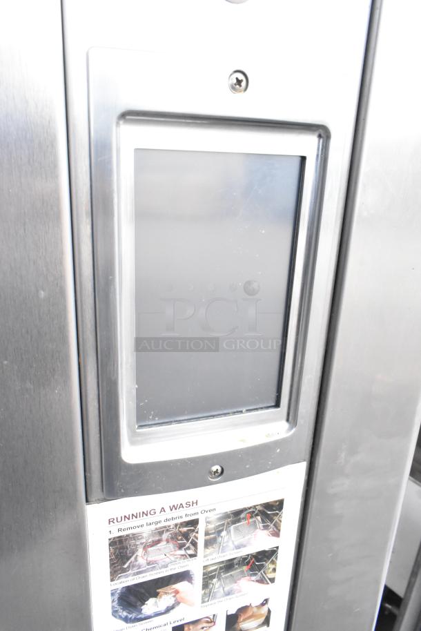 Baxter BV400G stainless steel gas mini rotating rack oven with touchscreen and wash instructions, on commercial casters.