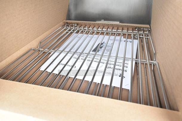 Brand new 2025 Cleveland 24CGA10 steam cabinet, showing stainless steel racks and manual. Scratch and dent condition.