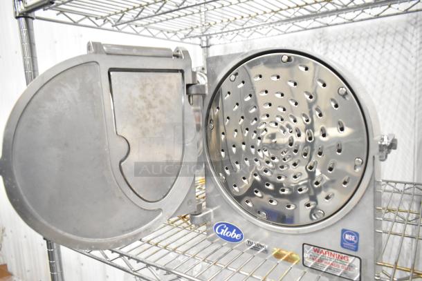 Brand new Globe metal commercial pelican head with shredding blade, shown open on metal shelf. Features Globe logo, NSF certification.