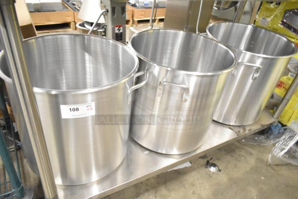 3 brand new Vollrath stainless steel stock pots on display, featuring handles and marked with a tag showing quantity 3.