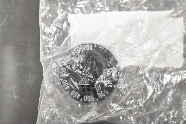 5 brand new items including coil, thermostatic control, and basket, wrapped in plastic. Markings show temperature settings 200-550.