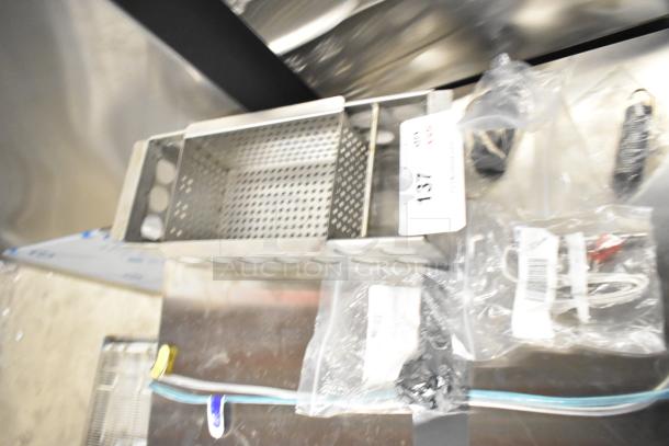 Five brand new items including a coil, thermostatic control, and metal basket, labeled with auction tag "137".