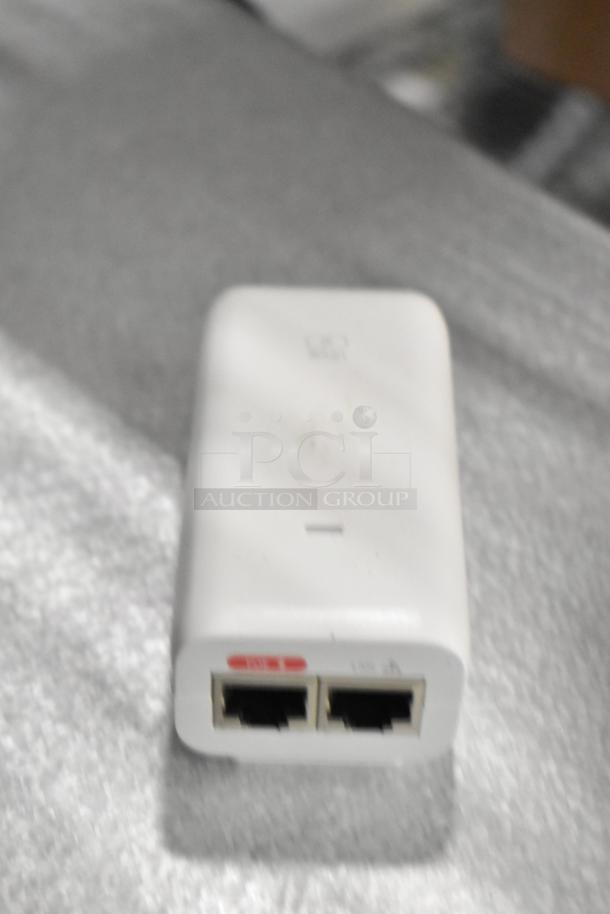 White device with two Ethernet ports, rectangular shape, slight wear visible. Part of a lot including a receipt printer and card reader.