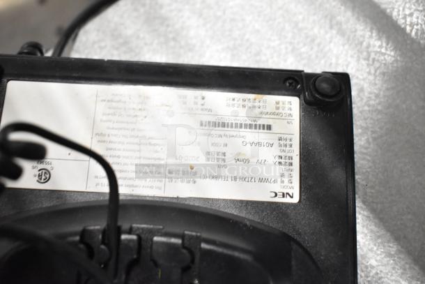NEC model label on black electronic device, showing model A07BA-G and input details. Device appears used.