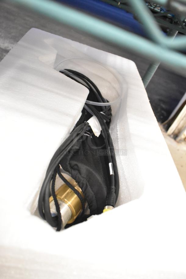 La Marzocco Modbar Espresso AV System components in packaging, showcasing cables and brass fittings. Brand new condition.