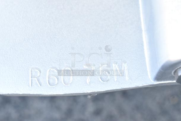 Close-up of "R60 75M" marking on a metallic surface, related to a Varimixer VBOWL-60 60-quart mixing bowl.