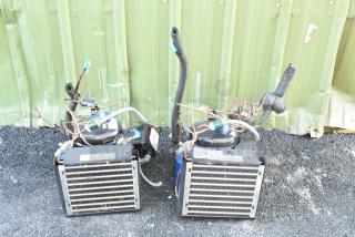 Two brand new Copeland M7JP-H021-IAA-072 compressors. 115 volts, 1 phase. Includes cooling coils, labels visible.