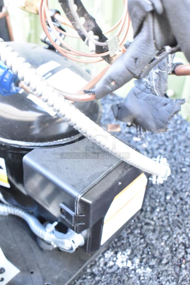 Brand new Copeland M7JP-H021-IAA-072 compressor, 115V, 1 phase. Includes labeling and connections.