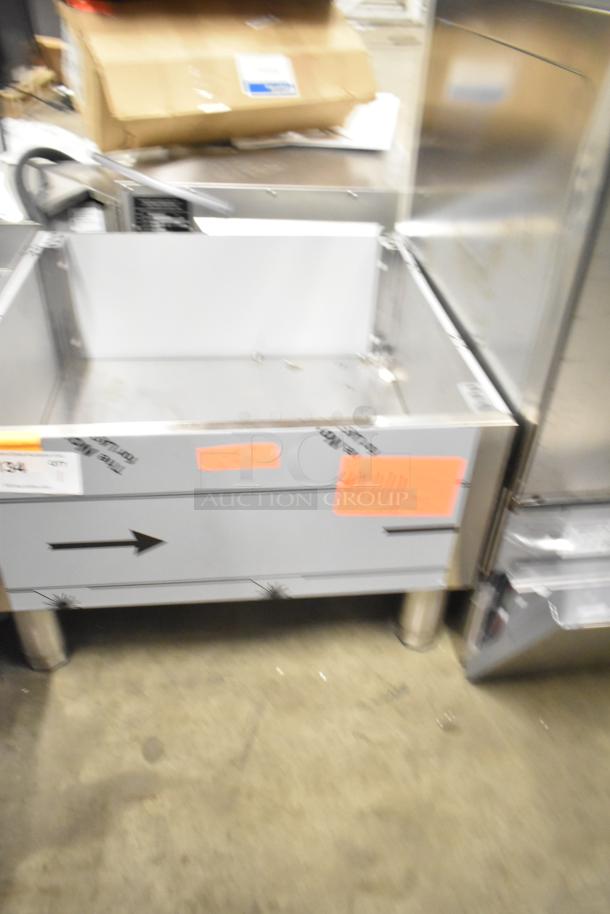 Brand new scratch and dent stainless steel bin, visible tape and labels, durable construction, ideal for kitchen use.