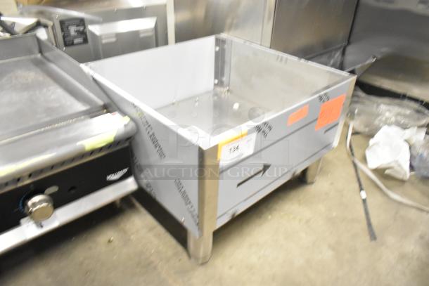 Brand new scratch and dent stainless steel bin with protective wrapping. Visible labels indicate recent inspection.