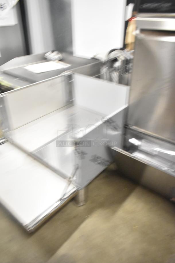 Brand new scratch and dent stainless steel bin, showing protective coating, slight dents visible, industrial design.