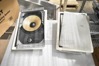 Two Control 126WT in-wall loudspeakers, featuring a beige woofer. Comes with protective grilles. Ideal for high-quality audio.