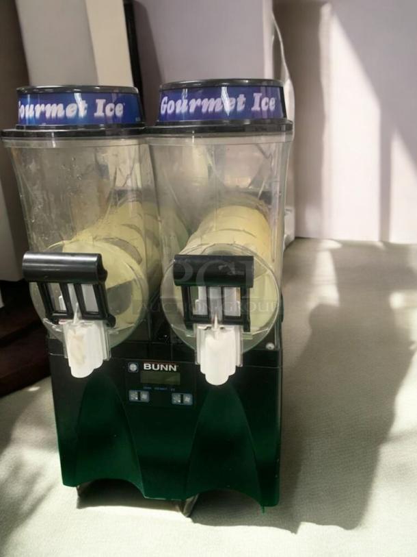 Taylor 340 frozen beverage machine in superb condition, dual dispensers, 208/230V. Fully tested and working, labeled "Gourmet Ice."