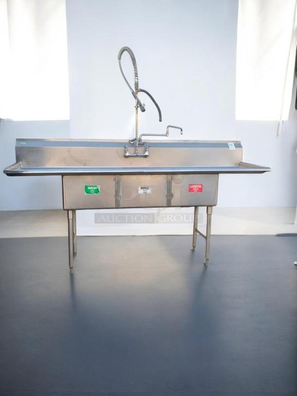 Prime condition stainless steel 3-compartment commercial sink with pre-rinse sprayer. Tags indicate wash, rinse, sanitize. Fully tested.