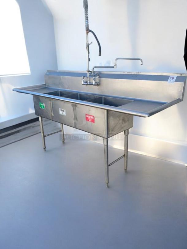 Heavy Duty stainless steel 3-compartment commercial sink with pre-rinse sprayer. Prime condition, labeled for wash, rinse, sanitize.