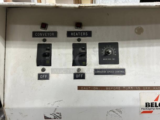 Belco Model ST shrink tunnel, tested and working, 220V, 1-phase. Features control switches, conveyor speed dial. Signs of wear.