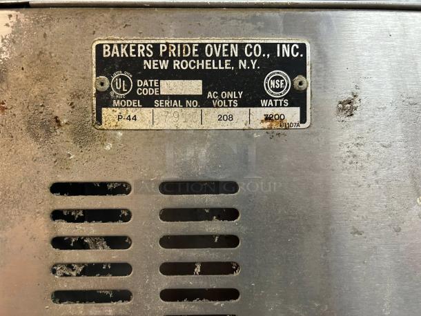 Bakers Pride P-44S oven label showing model, serial number, 208V, 7200W details; slight wear on stainless steel exterior.