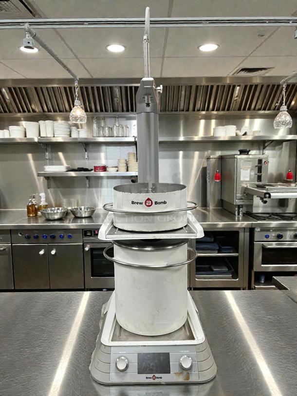 Brew Bomb ACE Brewer Coffee Maker, tested and working, in stainless steel. Features Brew Bomb logo and control panel.