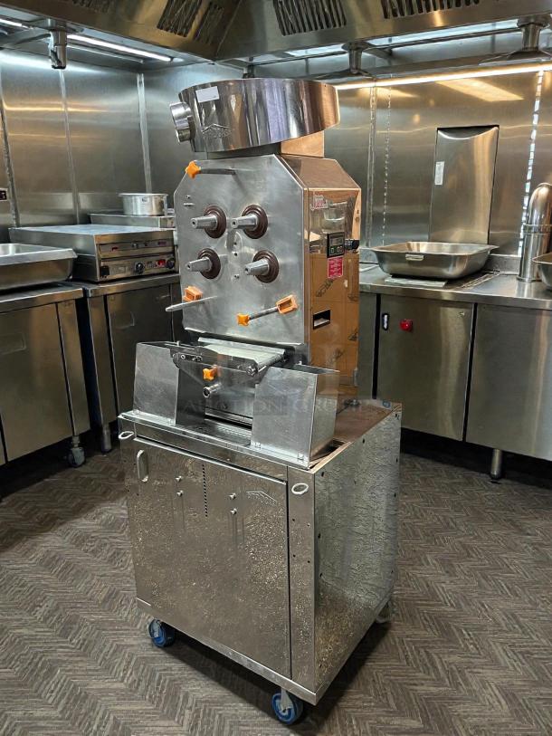 Citrocasa 8000 XB Advance Citrus Juicer, stainless steel, on wheels. In great condition, "As Is." Industrial kitchen setting.