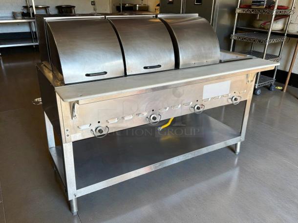 Duke 304 hot food table, 58 3/8", with 4 wells, cutting board, liquid propane, excellent condition, with covers.