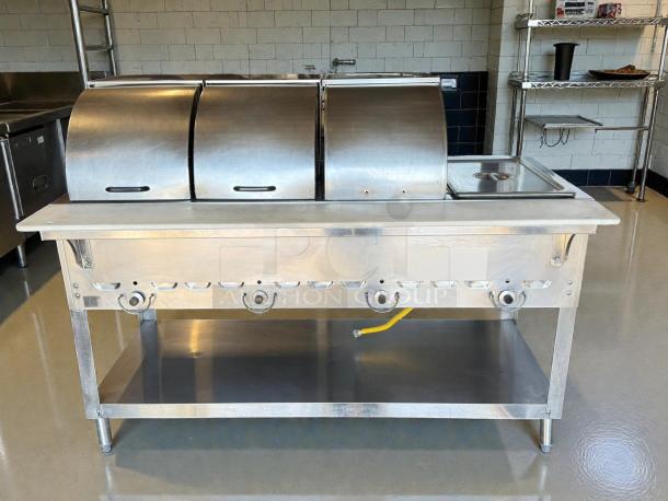 Duke 304 hot food table with 4 wells, cutting board, liquid propane. Includes covers. Steel construction, tested, great condition.