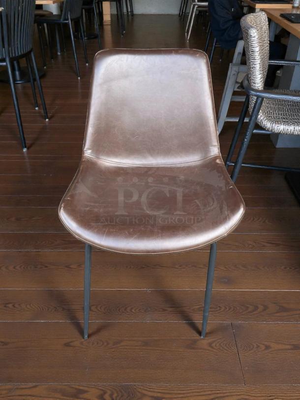 Zuo Modern Cedric faux leather Mid-Century Modern sled guest chair in great condition, brown seat, black metal legs.