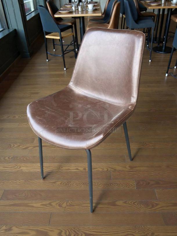 Mid-century modern Cedric chair by Zuo Modern. Faux leather seat, sled base design, excellent condition, brown finish.