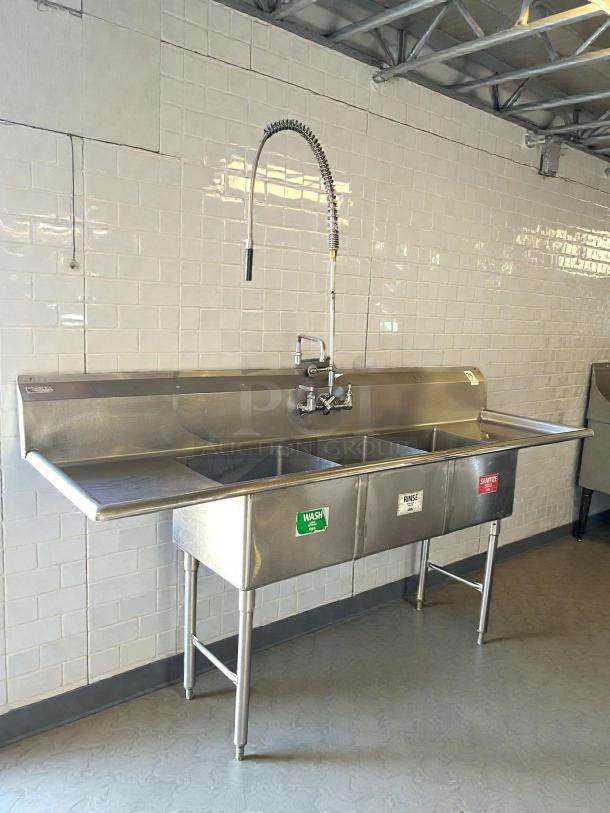 GSW USA SE18183D three-compartment sink with hand spray and faucet in excellent condition. Wash, rinse, sanitize labels visible.